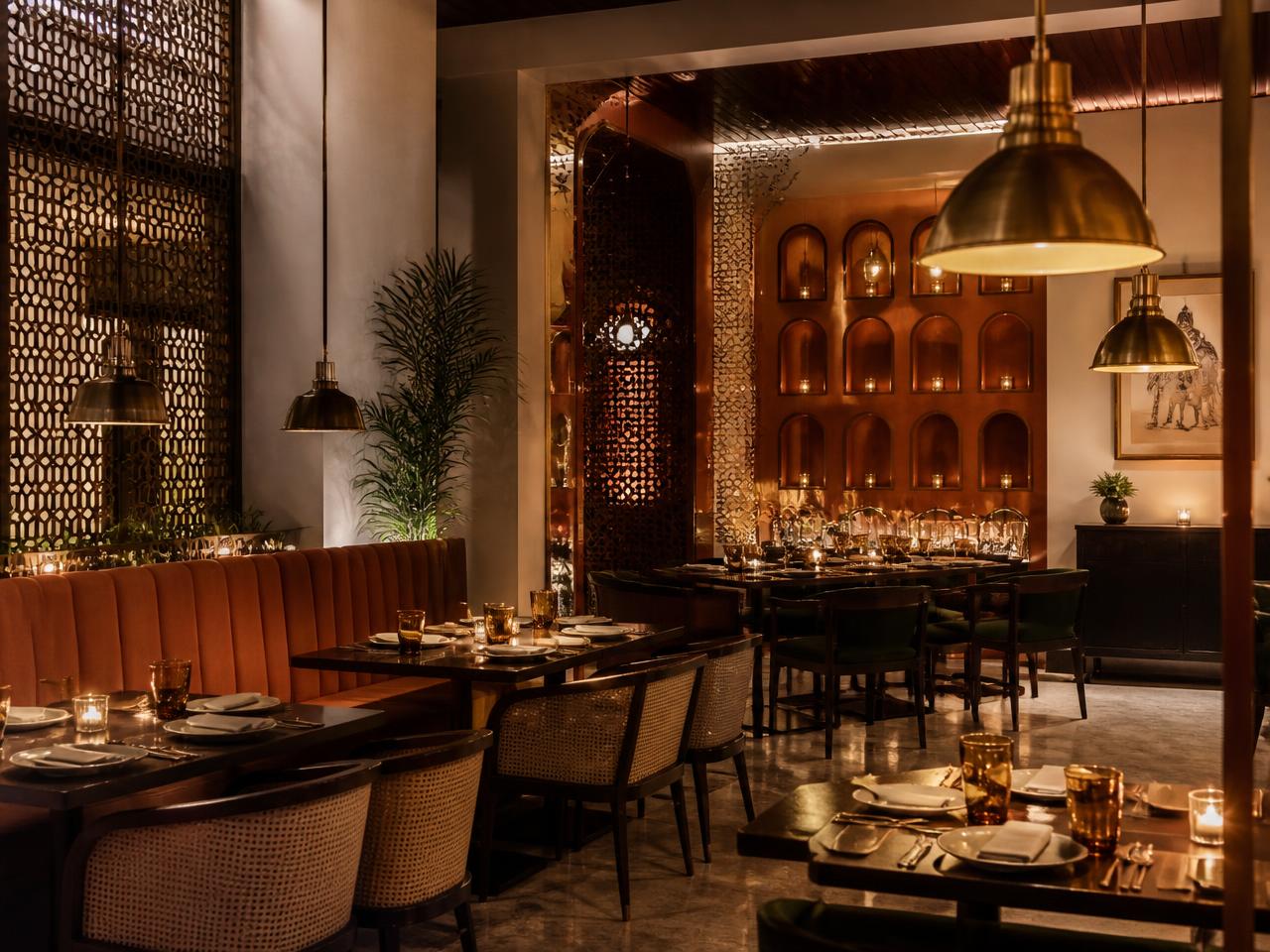 The warm dining room at Urban Tadka with brass pendant lights